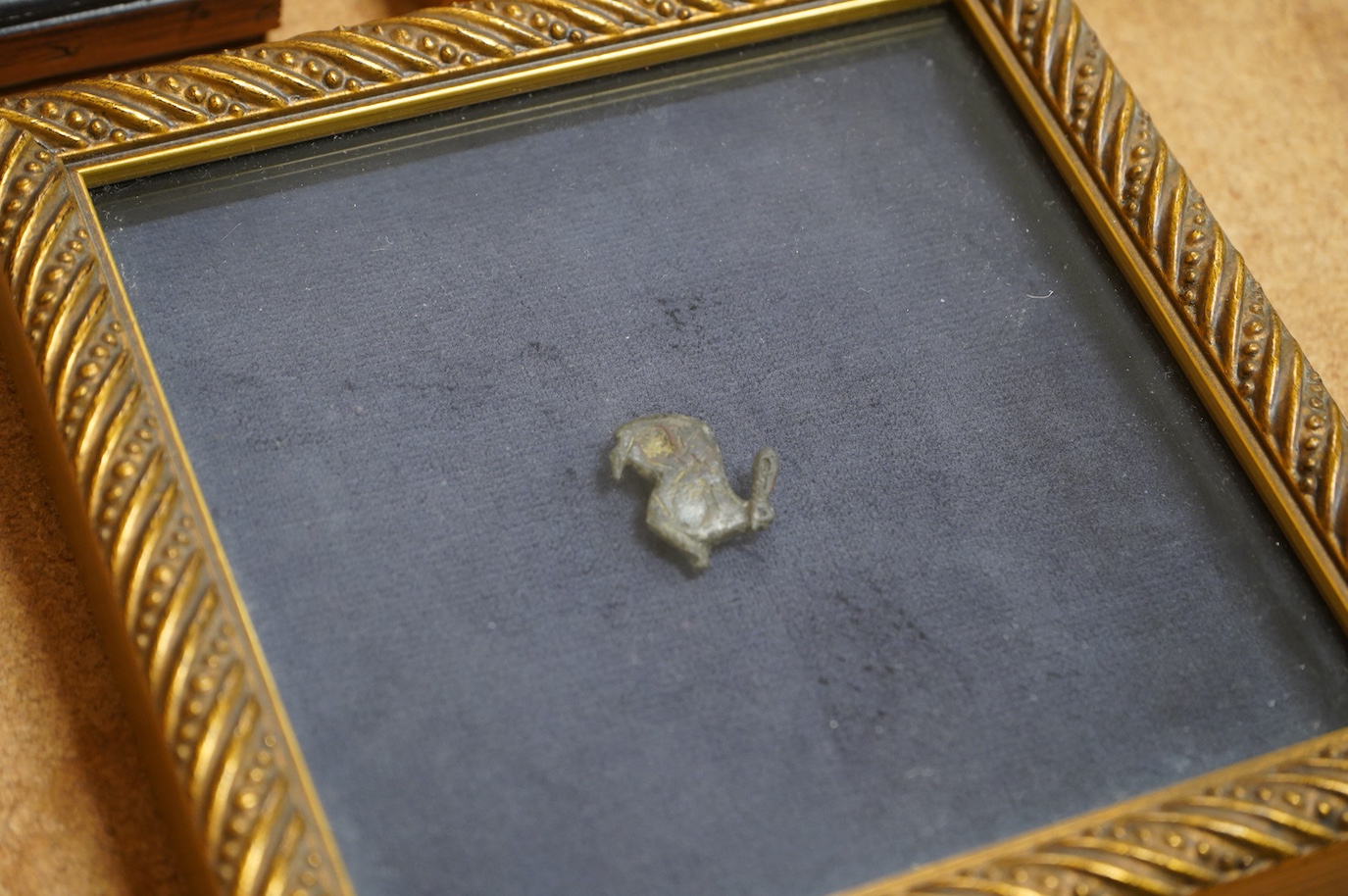 A Roman bronze badge, a medieval pewter badge and silver badges in the form of Sardinia emblems all framed., Swan badge 6cm wide, not including mount or frame. (Requires provenance)